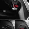 Close-up of a black aluminum alloy engine start stop button cover on a car interior panel.