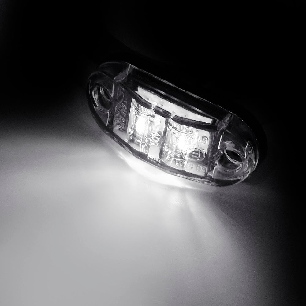 A close-up, black and white photo of a pair of LED side marker clearance lights.