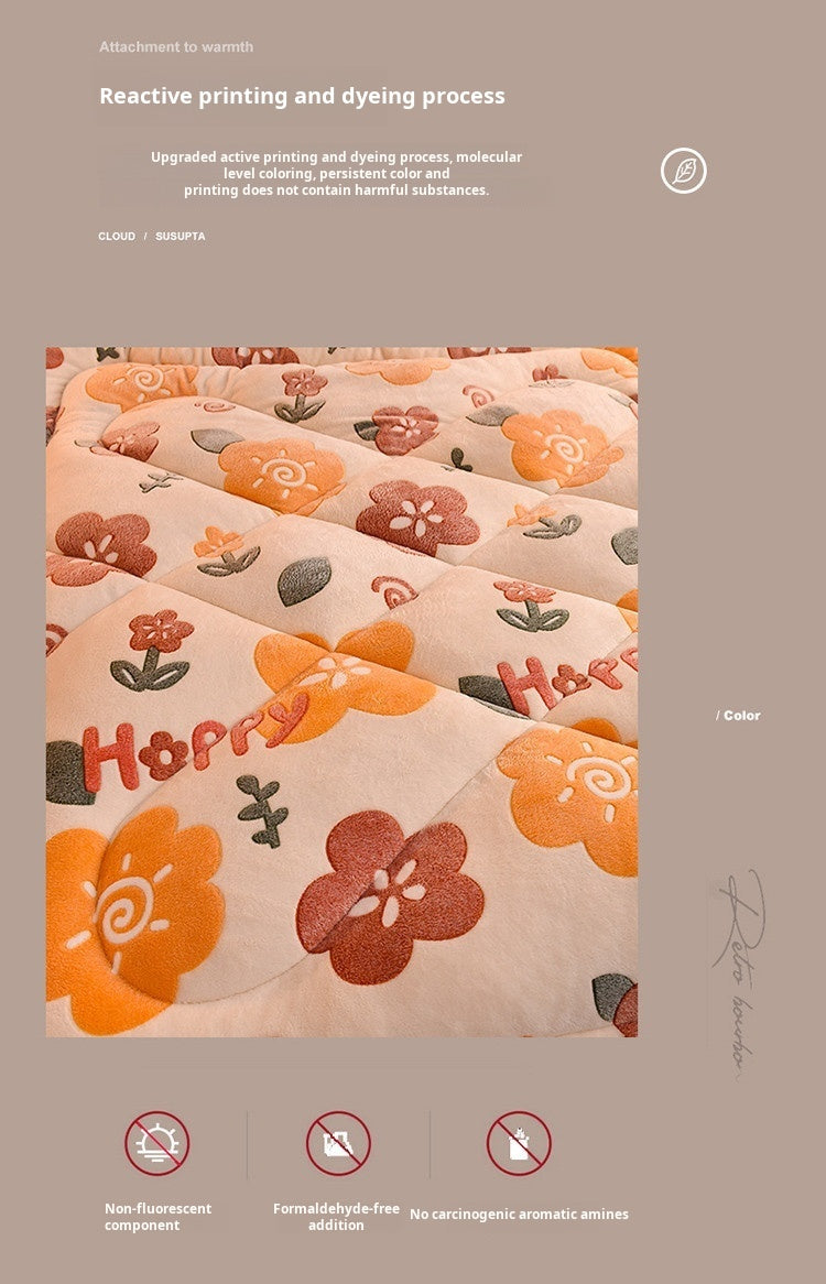 A close-up of a peach-colored fabric quilt featuring floral embroidery and text on a neutral background.