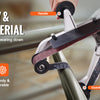 A hand is holding an angle grinder with various attachments including a handle, protective cover, active wheel, sand belt, an