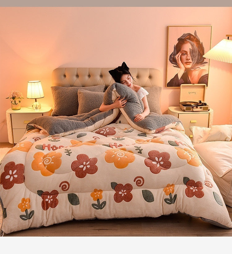A cozy double-sided velvet warm quilt blanket is displayed on a bed with soft lighting.