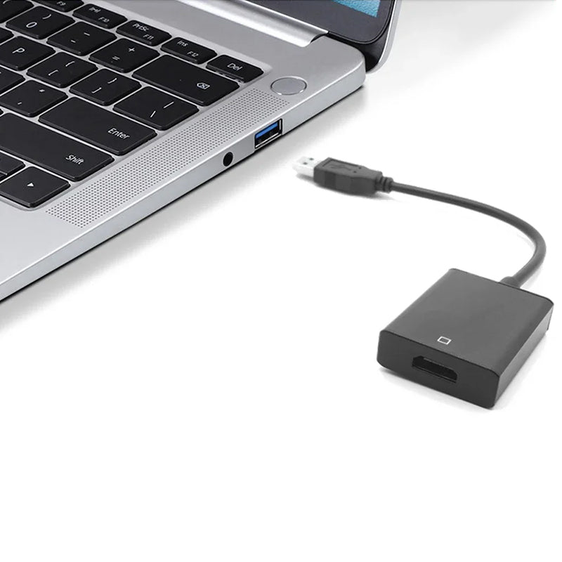 A silver laptop with a USB 3.0 to HDMI adapter plugged into the side port.
