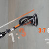 A man wearing an orange cap is using a 3:7 golden ratio tool to sand drywall, demonstrating efficient movement.