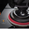 A close-up view of a heavy-cut wool polishing pad being used on a surface.