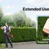 A person using a gas-powered hedge trimmer with dual shoulder straps for extended use and comfort.