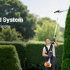A man operates a 4-in-1 all-around yard system hedge trimmer with a powerful 26cc two-stroke gas engine.