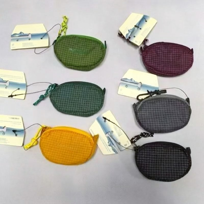 Collection de pochettes et de casques en nylon à carreaux de différentes couleurs : vert, violet, jaune et noir.