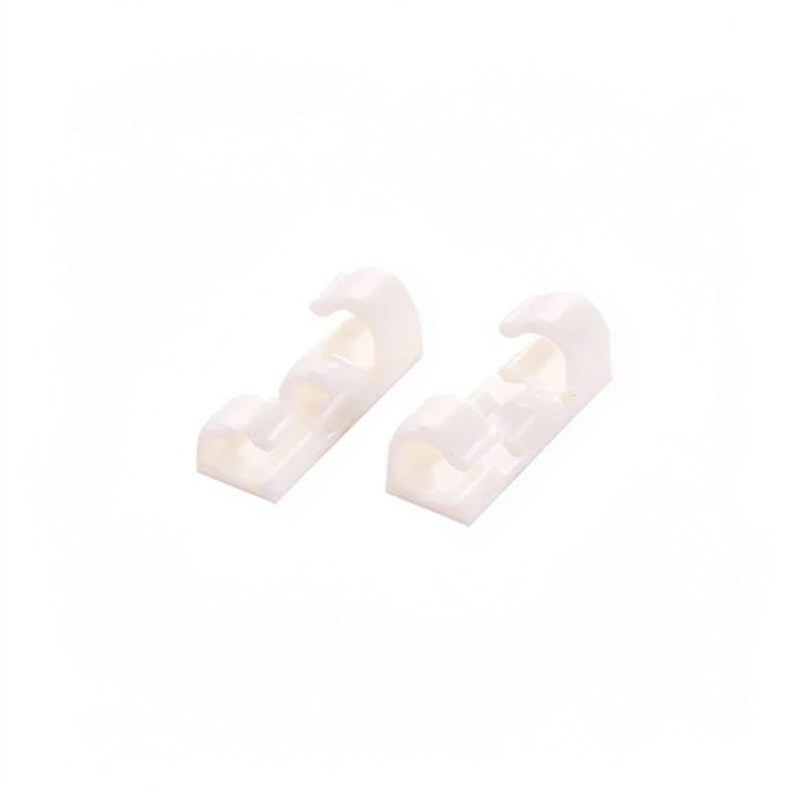 Two white desktop cable management clips shown from above