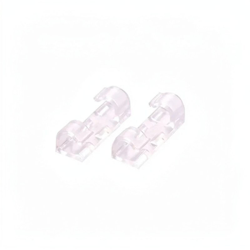 A pair of clear plastic desktop cable management clips for organizing wires.