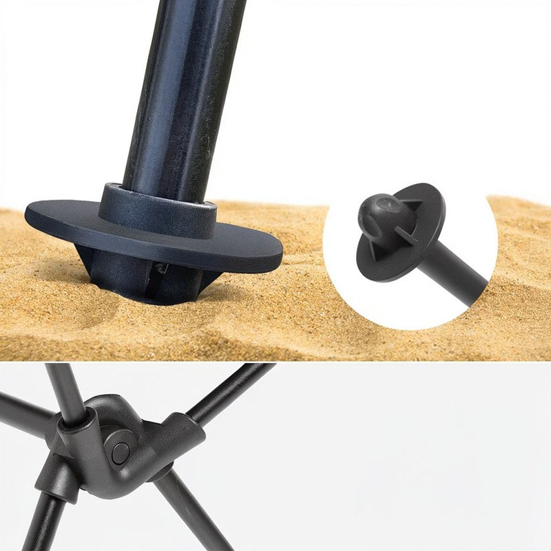 Nahaufnahme eines schwarzen faltbaren Campingstuhls mit Kopfstütze auf Sand.