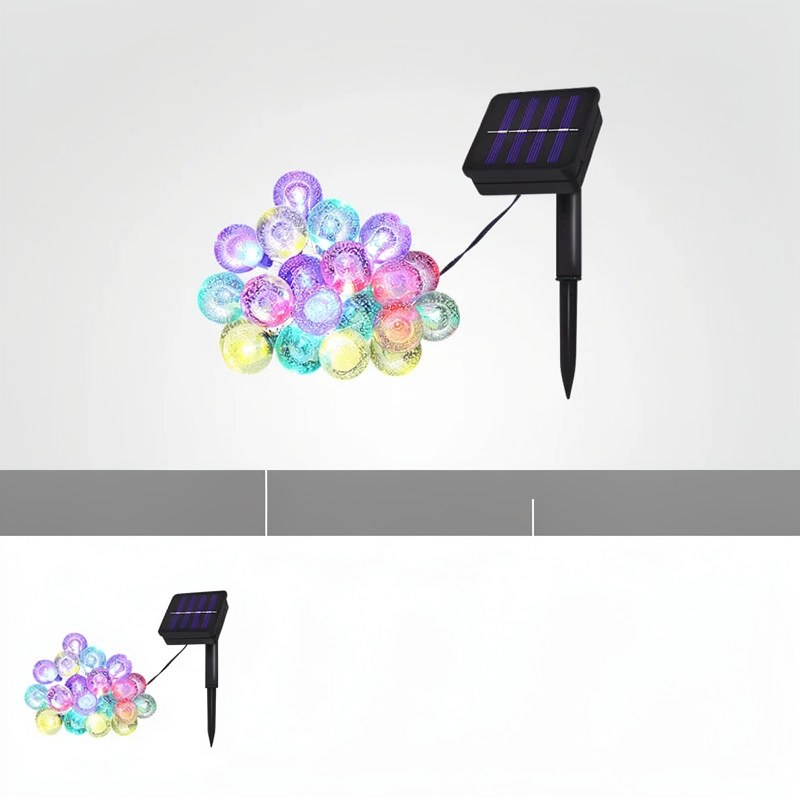 A string of colorful crystal globe lights is shown next to a black solar-powered light fixture.