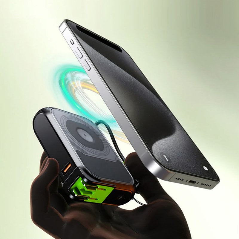 A hand holds a black Rugged 20,000mAh power bank with wireless charging, showing its sleek design.
