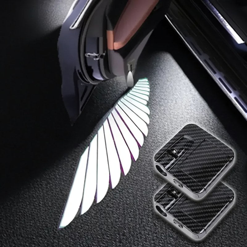 A close-up of a wireless LED car door logo projector illuminating a silver feather shape on a dark surface.