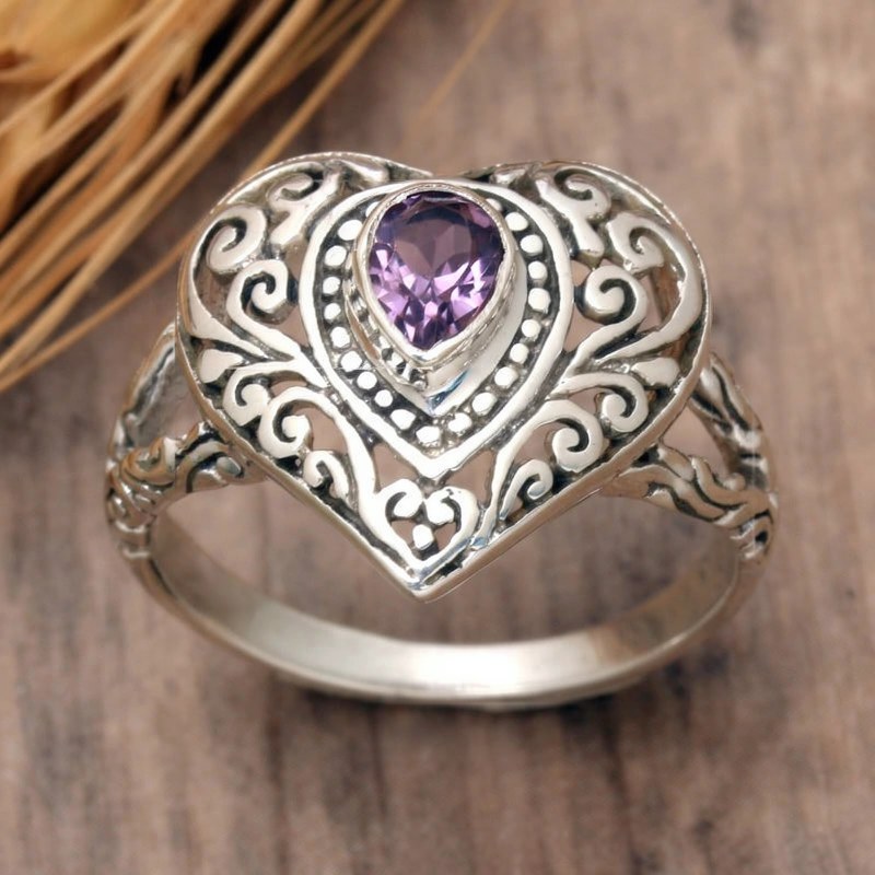 Silver vintage heart ring featuring a purple cubic zirconia gemstone set in an ornate design.